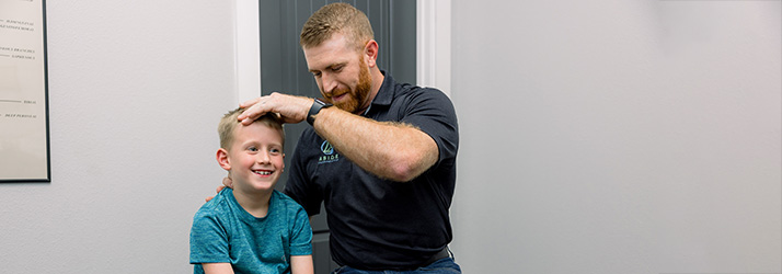 Chiropractor Fayetteville AR Parker Watkins with Kid Our Mission